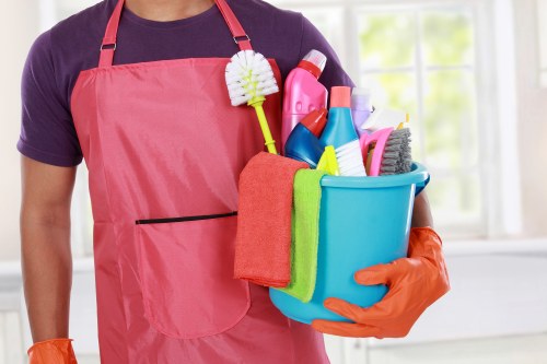 Carpet cleaning technician using safe working practices in a Ruislip property